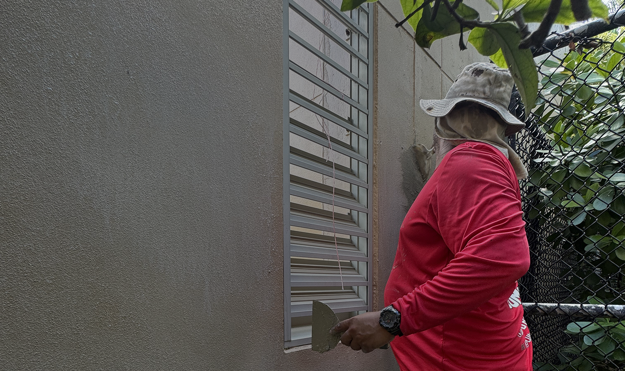 Painter preparing an exterior wall